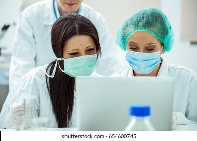 a group of lab experts working in a lab - Shutterstock ID 654600745