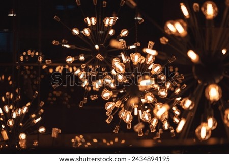 Group of lamps with interesting shape of tungsten filament. Detail of rounded light bulbs in low key.