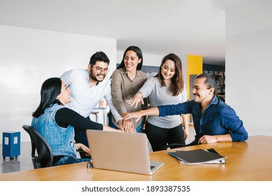 Group Of Latin Business People Working Together As A Teamwork While Sitting At The Office Desk In A Creative Office In Mexico City