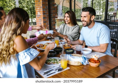 Group Of Latin Friends Eating Mexican Food In The Restaurant Terrace In Mexico Latin America