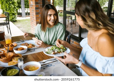 Group Of Latin Friends Eating Mexican Food In A Restaurant Terrace In Mexico Latin America