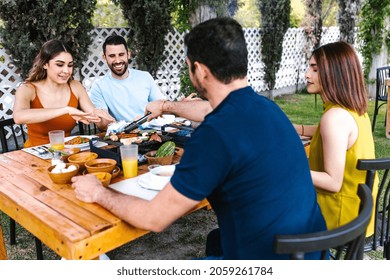 Group Of Latin Friends Eating Mexican Food In A Restaurant Terrace In Mexico Latin America