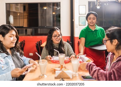 Group Of Latin Friends Eating Mexican Food In A Restaurant