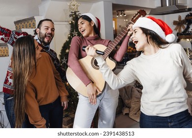 group of Latin friends singing in karaoke party celebrating christmas eve at home in Mexico Latin America, hispanic people in holidays - Powered by Shutterstock