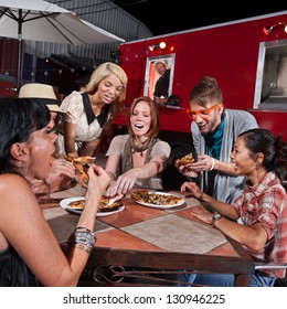 Group Of Laughing People Eating Pizza At A Food Truck