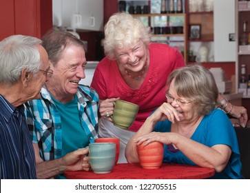 Group Of Laughing Seniors In A Coffeehouse