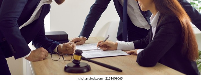 Group Of Lawyers Signing Papers While Working With Lawsuit Documents. Young Woman Putting Signature On Contract Or Notary Agreement. Justice, Court, Law Services Concept. Banner Or Header Background