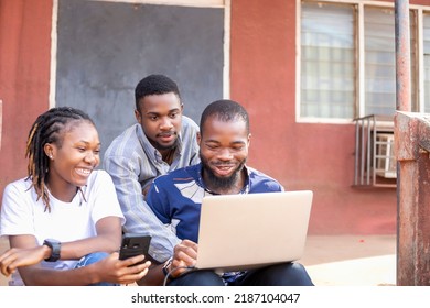 Group Of Learning Millennial African American Computer Science Students At University Or College Using Laptop And Mobile Phone Chatting Online