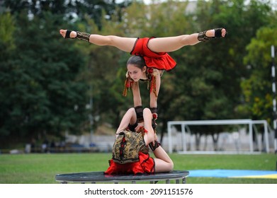 Group Of Little Girls Acrobats Doing Acrobatic Exercises On A Football Field. Celebration Of The Day Of Kyiv City. June 20, 2019.Kiev, Ukraine