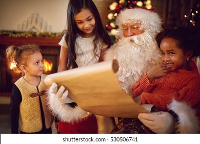 Group Of Little Multi Ethnic Girls Looking In Santa Claus Which Reading Wish List 