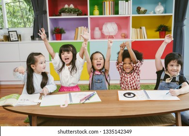 Group Of Little Preschool Kids Hands Up In Class . Portrait Of Children Diversity Education Concept.