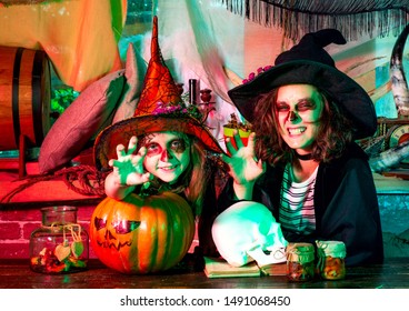 Group of little witch with a pumpkin and sweets. Happy Halloween Cute children making funny faces with a pumpkin - Shutterstock ID 1491068450