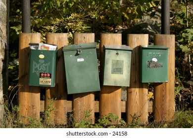 A group of mailboxes sitting in a row.