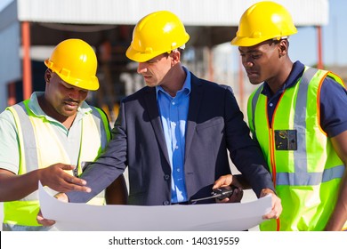 Group Of Male Architect And Construction Workers On Construction Site