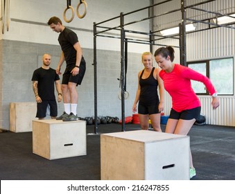 Group Of Male And Female Athletes Box Jumping