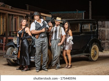 Group Of Male And Female Gangsters With Guns