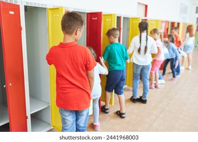 Group of male and female students standing near lockers in hallway at school - Powered by Shutterstock