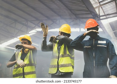 Group of male industrial workers are fleeing and covering their noses with their hands from the toxic fumes of toxic chemicals,ammonia,from violent explosions that make breathing dangerously difficult - Shutterstock ID 2133745177