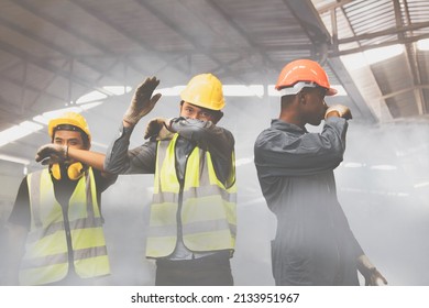 Group Of Male Industrial Workers Are Fleeing And Covering Their Noses With Toxic Fumes, Ammonia NH3 , And Toxic Chemicals From The Explosions, Causing Severe Breathing Difficulties