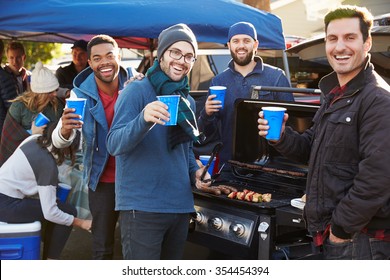 Group Of Male Sports Fans Tailgating In Stadium Car Park