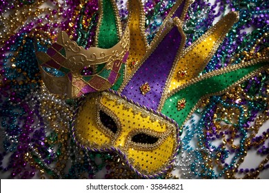 A Group Of Mardi Gras Beads And Mask With Copy Space