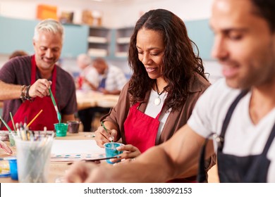 Group Of Mature Adults Attending Art Class In Community Centre