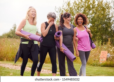 Group Of Mature Female Friends On Outdoor Yoga Retreat Walking Along Path Through Campsite - Shutterstock ID 1549485032