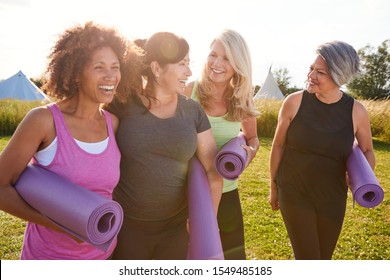 Group Of Mature Female Friends On Outdoor Yoga Retreat Walking Along Path Through Campsite - Shutterstock ID 1549485185