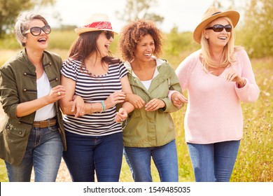 Group Of Mature Female Friends Walking Along Path Through Yurt Campsite - Shutterstock ID 1549485035