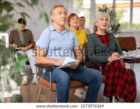 Group of mature students attending lecture in college