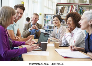 Group Of Mature Students Collaborating On Project In Library - Powered by Shutterstock