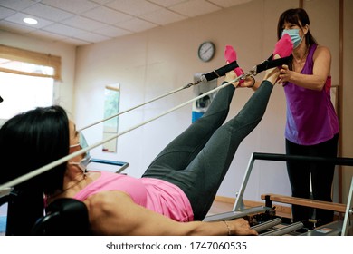 Group Of Mature Women Doing Excercise, Pilates And Yoga With Social Distancing And Face Mask