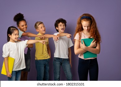 Group of mean schoolchildren bullying their upset red-haired classmate on violet background