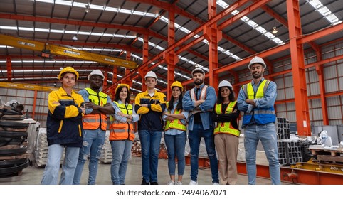 A group of mechanical engineers from different cultures and ethnicities get together in front of the metal steel factory express their commitment to get the project done. Diverse cultures in workplace - Powered by Shutterstock