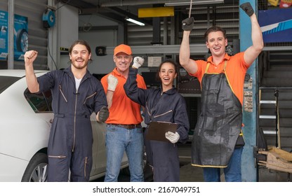 Group Of Mechanics Men And Woman Raising Hands To Work Success At Auto Service Garage.Staff Car Service Team Worker Maintenance And Repair Vehicle.