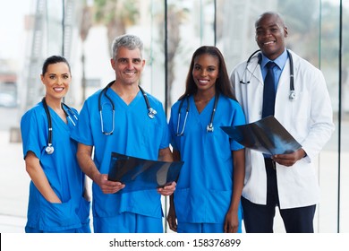 Group Of Medical Doctors In Office With Patient's X-ray