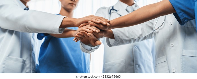 Group of medical staff doctor nurse and healthcare specialist profession coordinating synergy hand in hospital. Medical teamwork and healthcare cooperation in panoramic banner background. Neoteric - Shutterstock ID 2332675663