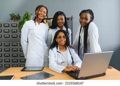 Group Of Medical Staff Posing For Photo Around Table In Hospital