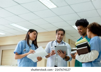 Group Of Medical Student And Teacher Standing Looking Work In Tablet. Education And Learning Medical Concept.