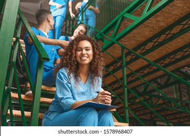 Group Of Medical Students On Stairs In Modern Clinic