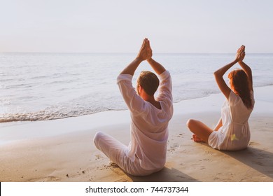 Group Meditation, Yoga On The Beach At Sunset