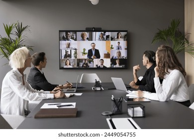 Group meeting using video call app. Multiethnic businesspeople profiles on screen, engaged in teleconference event by business, international communication of HR managers and applicants, career, tech - Powered by Shutterstock