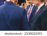 Group of men in business suits talking and discussing during coffee break at conference, politicians and entrepreneurs networking and negotiate, businessmen have dialog conversation, decision making