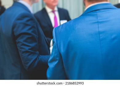 Group Of Men In Business Suits Talking And Discussing During Coffee Break At Conference, Politicians And Entrepreneurs Networking And Negotiate, Businessmen Have A Conversation