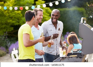 Group Of Men Cooking On Barbeque At Home