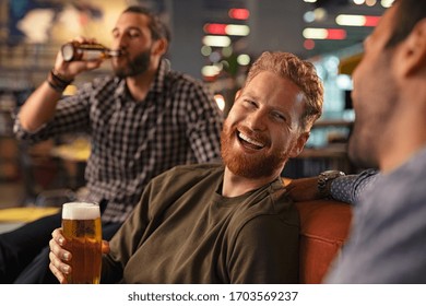 Group Of Men Friends Enjoying Night Out At Rooftop Bar. Old Friends Having Fun And Drinking Draft Beer At Pub. Group Of Three Men Drinking Fresh Beer And Having Conversation During Evening At Pub.