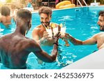 Group of men friends toasting drinks in pool - celebration cheer - vibrant poolside party, tropical cocktails - joyful gathering.