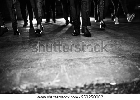 a group of men or gangsters in suit walking in dramatic lighting