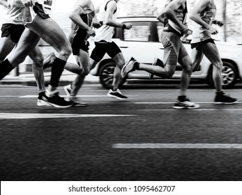 group men runners running street on marathon black-and-white image