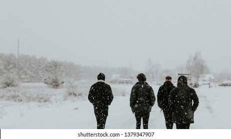 Group of men walking in the snow - Powered by Shutterstock